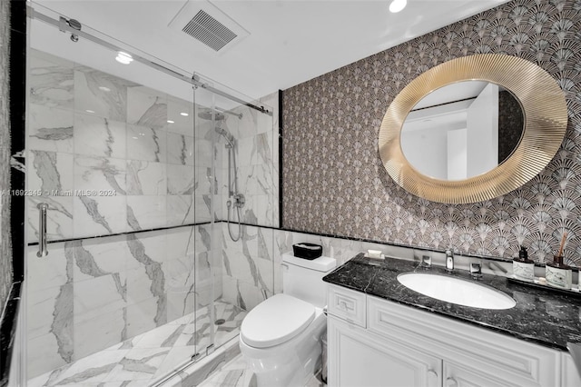 bathroom with vanity, a shower with shower door, tile walls, and toilet