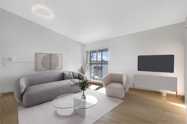 living room featuring hardwood / wood-style floors and vaulted ceiling