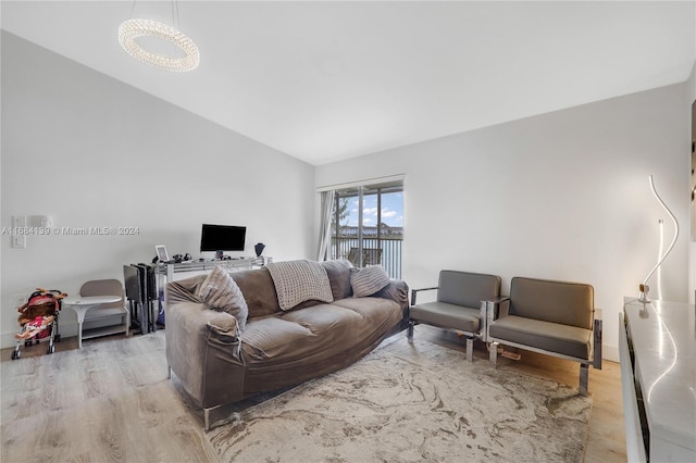 living room featuring vaulted ceiling and light wood-type flooring