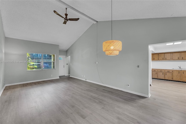 7243 W Sunrise Blvd Unit 7243K, Plantation, FL 33313 - unfurnished living room with wood finished floors, a ceiling fan, beamed ceiling, a textured ceiling, and high vaulted ceiling
