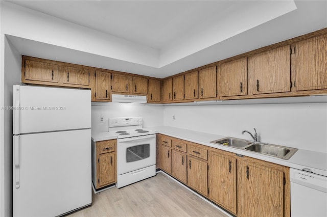 7243 W Sunrise Blvd Unit 7243K, Plantation, FL 33313 - kitchen with white appliances, under cabinet range hood, light wood finished floors, and brown cabinets