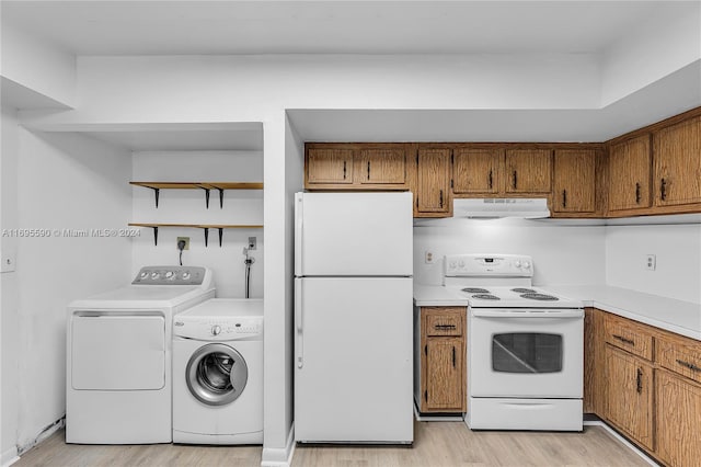 kitchen featuring ventilation hood, independent washer and dryer, light wood-type flooring, and white appliances