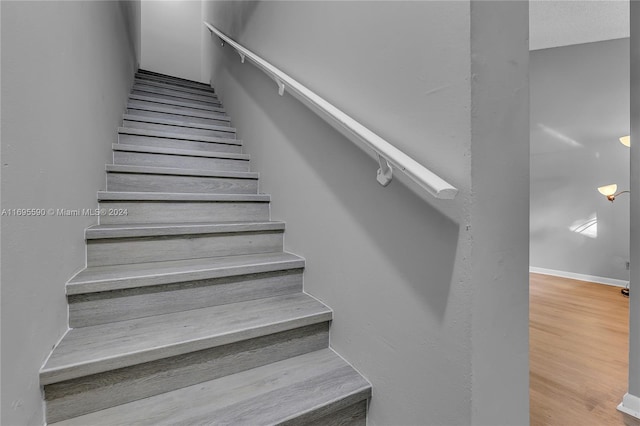 staircase featuring hardwood / wood-style flooring