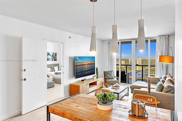 living room with expansive windows and light hardwood / wood-style flooring