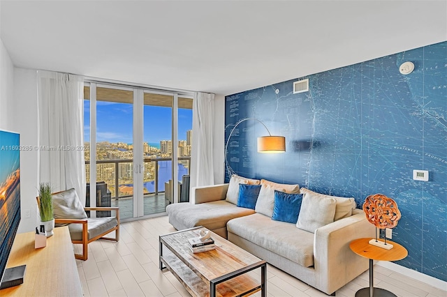 living room with a water view and a wall of windows