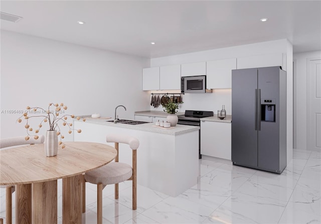 kitchen featuring sink, white cabinets, and appliances with stainless steel finishes