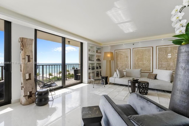 living room featuring expansive windows, a water view, and light tile patterned flooring