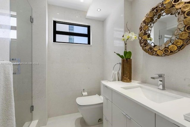 bathroom with vanity, a shower with shower door, and toilet