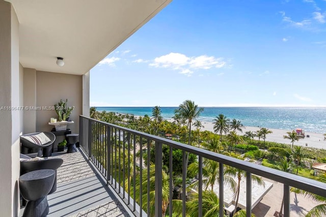 balcony featuring a beach view and a water view