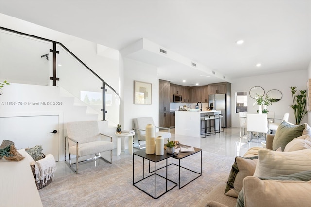 living room featuring visible vents and recessed lighting