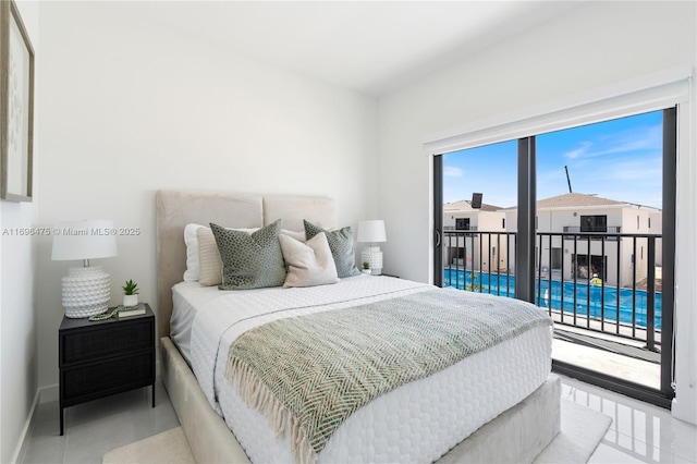 bedroom featuring baseboards and access to outside