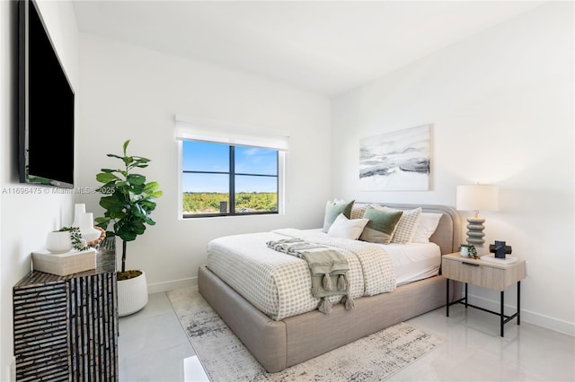 bedroom with tile patterned floors and baseboards