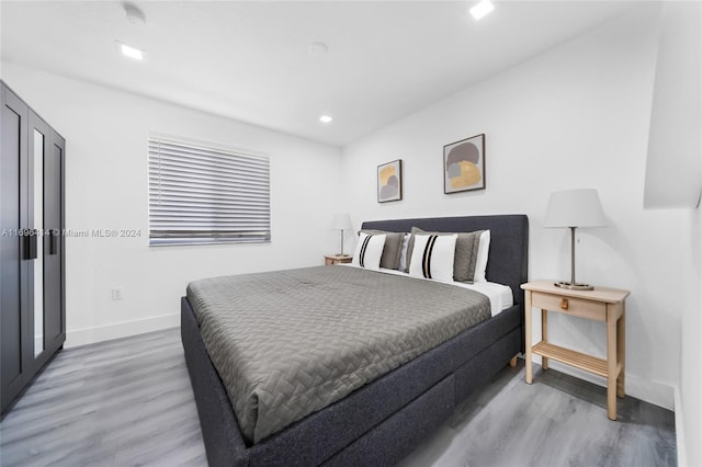 bedroom with hardwood / wood-style floors