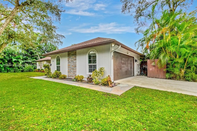 view of front of property with a garage and a front yard