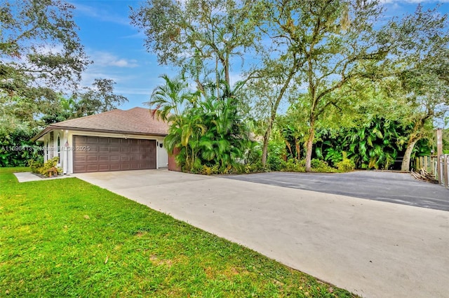 view of front of house with a garage and a front yard