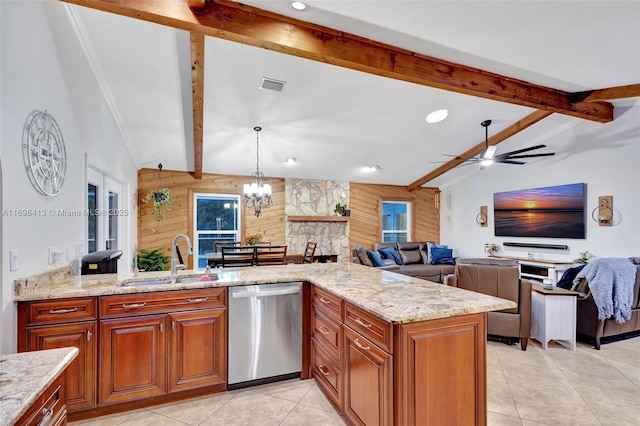 kitchen with sink, wood walls, light stone counters, lofted ceiling with beams, and stainless steel dishwasher