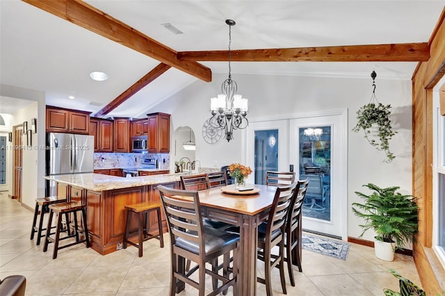 dining area featuring an inviting chandelier, sink, light tile patterned floors, and vaulted ceiling with beams