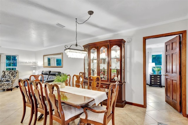 tiled dining space featuring ornamental molding