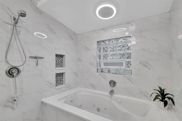 bathroom featuring tiled tub