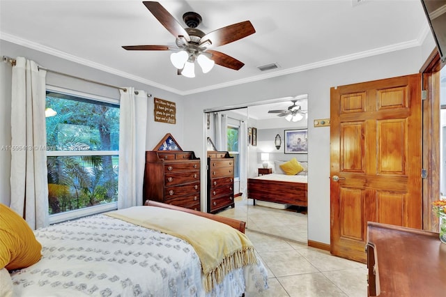 tiled bedroom featuring multiple windows, ceiling fan, ornamental molding, and a closet