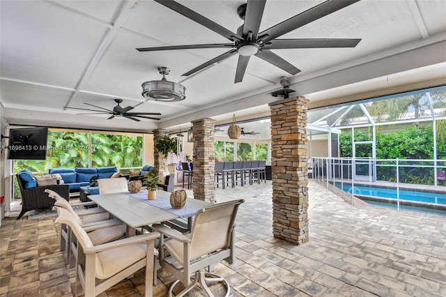 view of patio / terrace featuring ceiling fan, an outdoor living space, and exterior bar