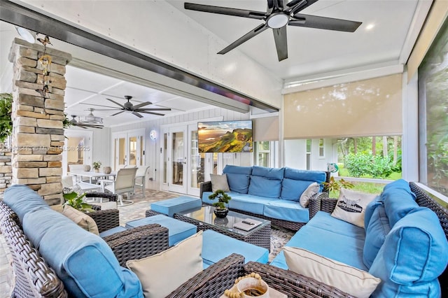 sunroom / solarium featuring french doors and ceiling fan