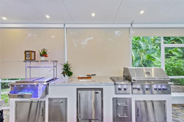 view of patio / terrace featuring grilling area and an outdoor kitchen