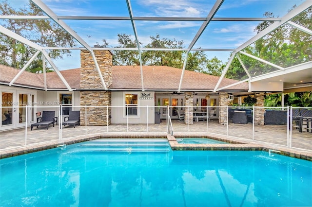 view of swimming pool featuring a lanai, a patio area, ceiling fan, and french doors