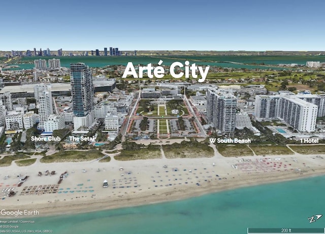 aerial view with a water view and a view of the beach