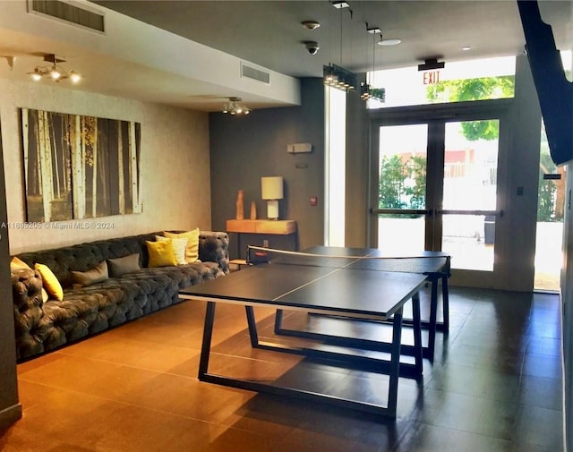 recreation room with tile patterned floors and french doors