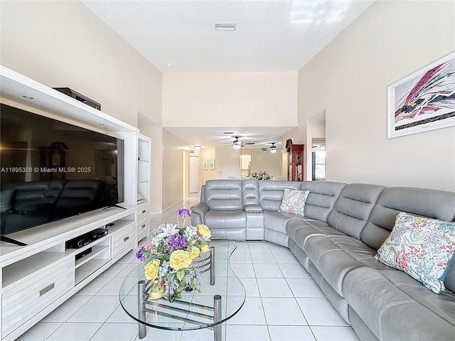 tiled living room featuring ceiling fan