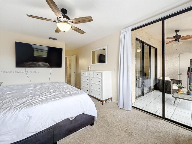 carpeted bedroom featuring ceiling fan and a textured ceiling