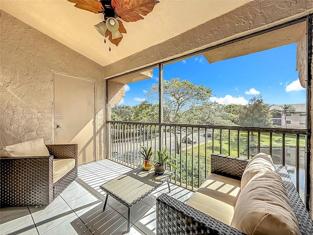 balcony with ceiling fan and an outdoor living space