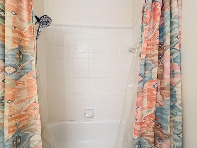 bathroom with shower / bath combo with shower curtain