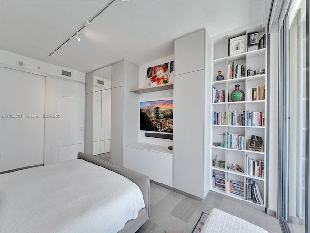 bedroom featuring a closet and track lighting