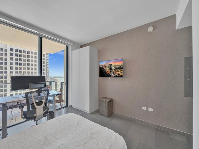 bedroom featuring floor to ceiling windows, electric panel, and multiple windows