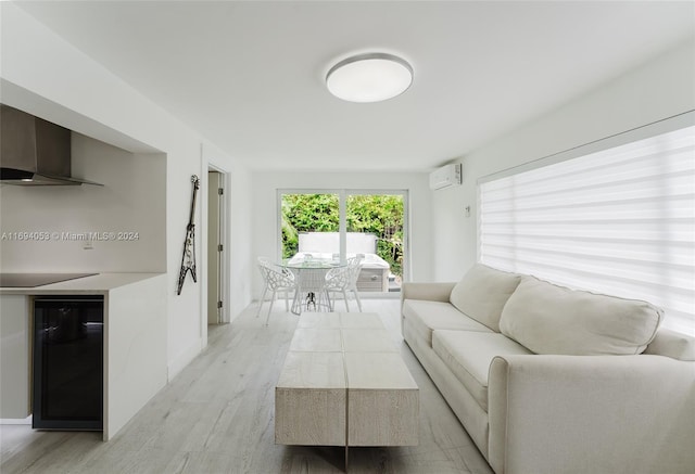 living room with light hardwood / wood-style flooring and a wall mounted air conditioner