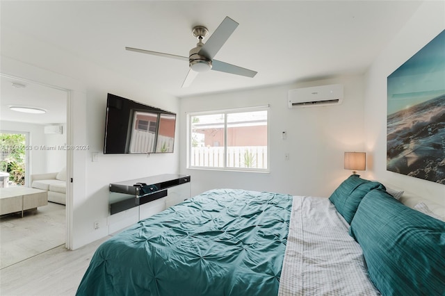 bedroom featuring a wall mounted air conditioner and ceiling fan