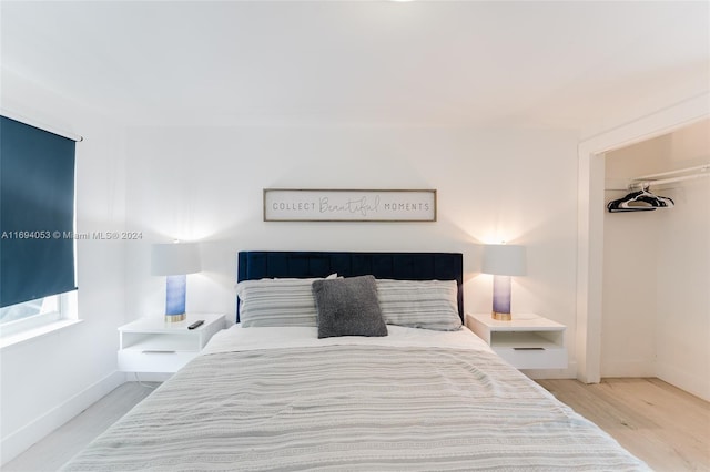 bedroom featuring light wood-type flooring and a closet