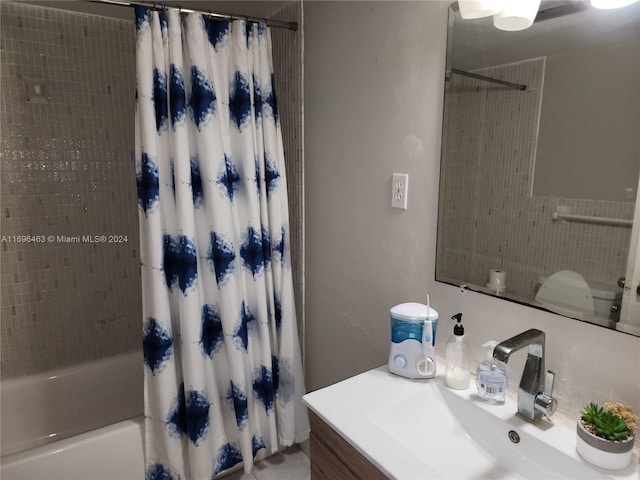 bathroom featuring shower / bath combo with shower curtain and vanity