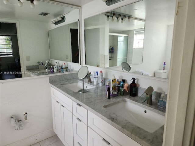 bathroom featuring vanity, tile patterned floors, and plenty of natural light