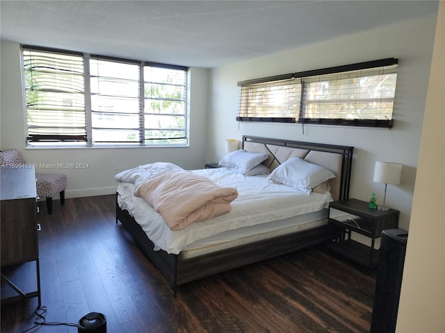 bedroom with dark hardwood / wood-style floors