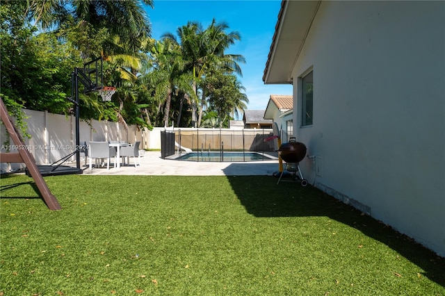 view of yard featuring a patio area and a fenced in pool