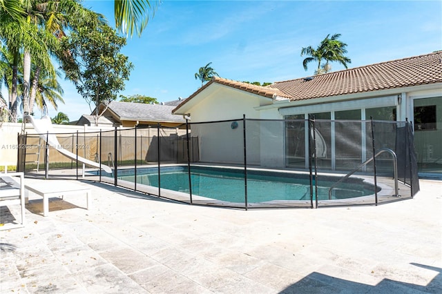 view of pool featuring a patio area and a water slide