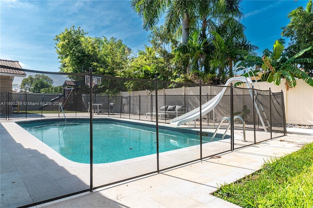 view of pool with a water slide