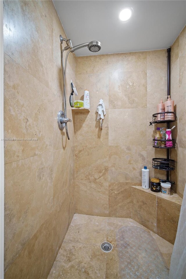 bathroom with tiled shower