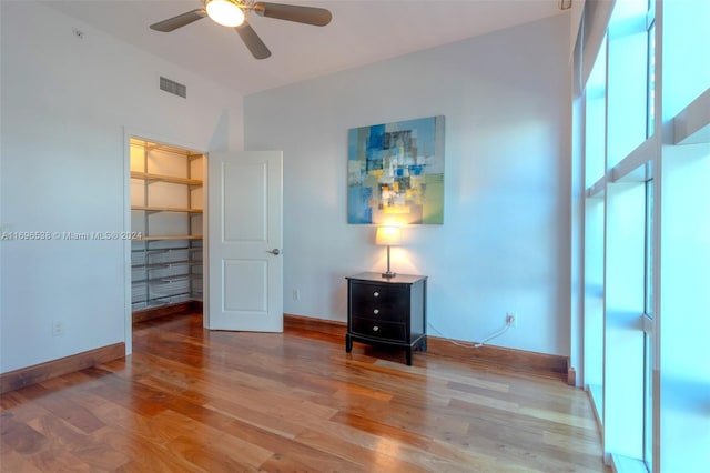 unfurnished bedroom with hardwood / wood-style floors, a closet, and ceiling fan