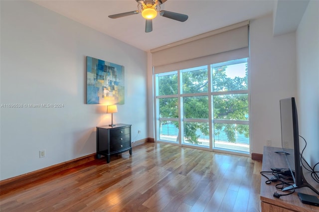 unfurnished room featuring hardwood / wood-style floors and ceiling fan