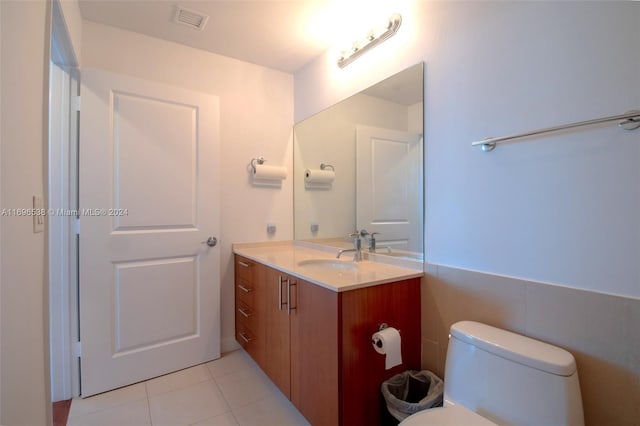 bathroom with tile patterned floors, vanity, and toilet