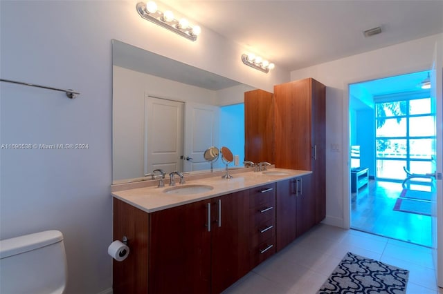 1945 S Ocean Dr Unit M5, Hallandale Beach, FL 33009 - bathroom featuring toilet, tile patterned flooring, double vanity, and baseboards